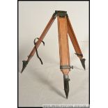 A good mid century wooden and enamelled metal tripod stand of chunky heavy construction ideal as a
