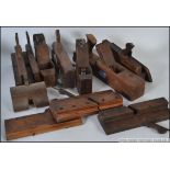 A collection of assorted vintage wooden carpenters planes,