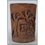 A 20th Chinese bamboo brush pot carved in details with family / pagoda village scenes complete with