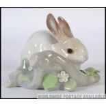 A Lladro ceramic Figure group of a Rabbit in a naturalistic setting by a Branch W11cm