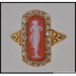An unmarked Italian gold ring tests for 18ct with central cameo of an ethereal maiden with a halo