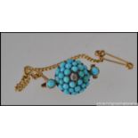 An Edwardian yellow metal brooch set with turquoise beads and a central diamond in a star setting