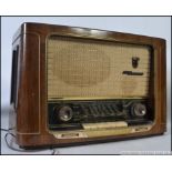 A vintage 1940's / 1950's Grundig 3D valve radio with decorative facia inset a walnut case