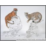 A Franklin mint collectors pair of wildlife figures to include a crouching Leopard and Tiger both