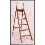 A vintage mid century folding painters wooden ladder having handles to top in good condition