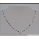 An 18ct white gold and blue diamond ladies necklace.