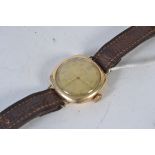 A vintage mens Ingersoll Rolled gold watch with brown leather strap.