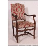 A 19th century walnut upholstered Osso Bucco French provincial fauteuil armchair having shaped legs