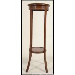An Edwardian mahogany inlaid torchere / plant stand.