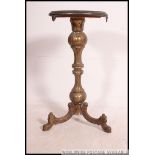 A 19th century gilt brass and rouge marble tripod table.