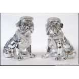 A pair of ceramic chromed bookends in the form of Pug's / Bull dogs, both in a seated position.