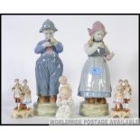 A collection of five pieces of Austrian 20th century bisque figures to include a Dutch boy and girl