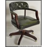 A 20th century antique style green leather and mahogany office swivel chair.