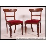 2 Victorian Regency mahogany bar back dining chairs raised on turned legs with red velour drop in