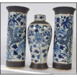 2 Chinese blue and white cylindrical salt glazed vases stylised with foliates and dragons together