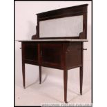 An Edwardian mahogany inlaid and marble top washstand cabinet raised on square tapered legs with