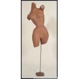 A vintage / retro posed point of sale shop advertising female mannequin's torso dummy,