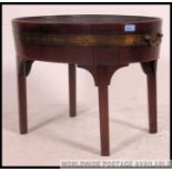 A 19th century George III mahogany coopered and brass bound oval wine cooler on stand being raised