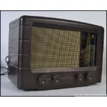 A vintage early 20th century Pye bakelite valve radio with decorative facia