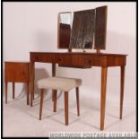 An original Gordon Russell walnut dressing table of five drawers with triple mirror having fabulous