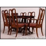 A large Regency style mahogany dining table together with a set of matching mahogany dining chairs