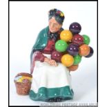 A Royal Doulton figurine HN1315 The Old Balloon Seller being stamped to the base with the old green
