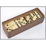 An early 20th century bone faced domino set complete in the original box