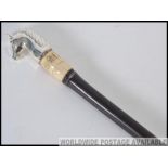 A 20th century gentleman`s cane having a silver metal horses head handle with an Ivory collar and