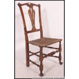 A 19th century country oak and rush seated nursing chair.