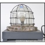 A vintage industrial bulkhead light, converted into a table lamp.
