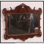 A Victorian flame mahogany and gilt rococo pier mirror.