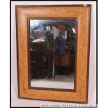 A large decorative 20th century mirror having stencil painted borders to the pine frame with