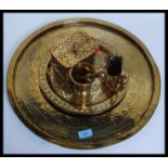 A collection of brass wares to include a large circular wall charger, an incense box,