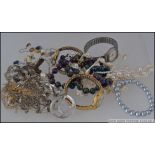 A collection of white and yellow metal and other costume jewellery to include watches, earrings,