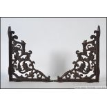 A pair of 20th century exterior wall hanging rust effect architectural brackets.