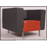 A great vintage retro orange and grey vinyl armchair on powder coated metal legs,