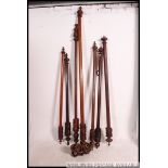 A collection of Victorian mahogany large curtain rails of think form being well carved with finial