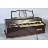 A vintage / retro 1970's Rosedale Electric Chord Organ musical instrument in brown plastic body