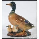 A fabulous life sized ceramic figure group of a Drake Mallard with his young,