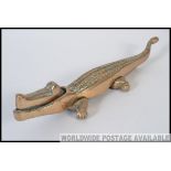 An early 20th century large cast brass nut cracker in the form of a crocodile L35cm