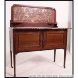 An Edwardian mahogany inlaid marble top washstand.