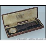A 9ct gold Edwardian gentlemans wristwatch leather half leather original strap,