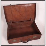 An early 20th century large high quality solid leather suitcase complete with the leather handle