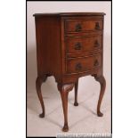 A Georgian style mahogany bow front pedestal chest of drawers being raised on cabriole legs with