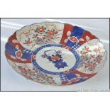 A 19th century Imari pattern plate with geometric red and blue borders having central