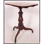 A 19th century Georgian mahogany tilt top tripod wine table.