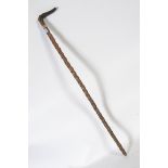 A hawthorn shafted walking cane with a gold metal collar,