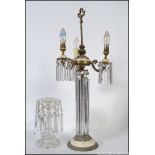 A stunning early 20th century table lamp lustre having long glass droplets under 3 branch lamp