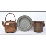 A Victorian copper twin handled mug of large form together with a copper kettle and a pewter plate