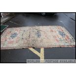 A large early 20th century handwoven Islamic / Persian rug having beige and red ground with blue